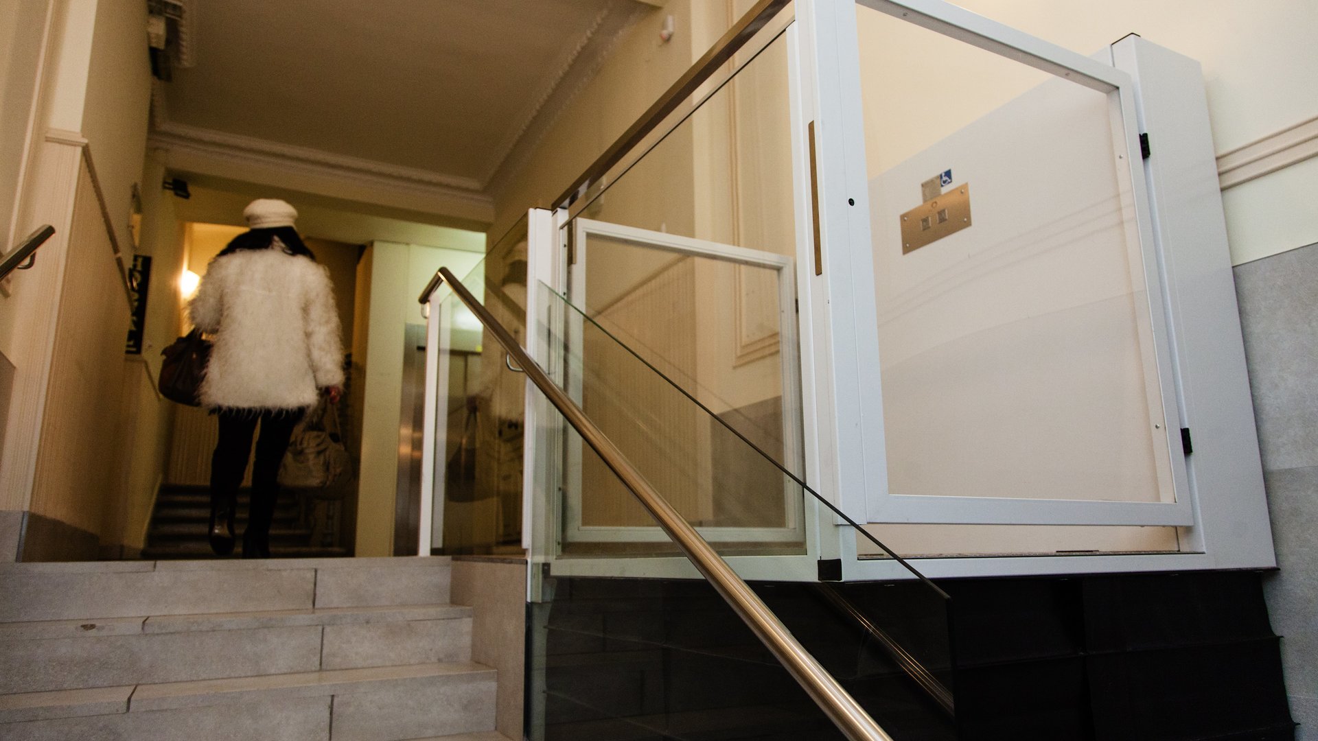 a woman who has accessed the portal using a vertical platform lift